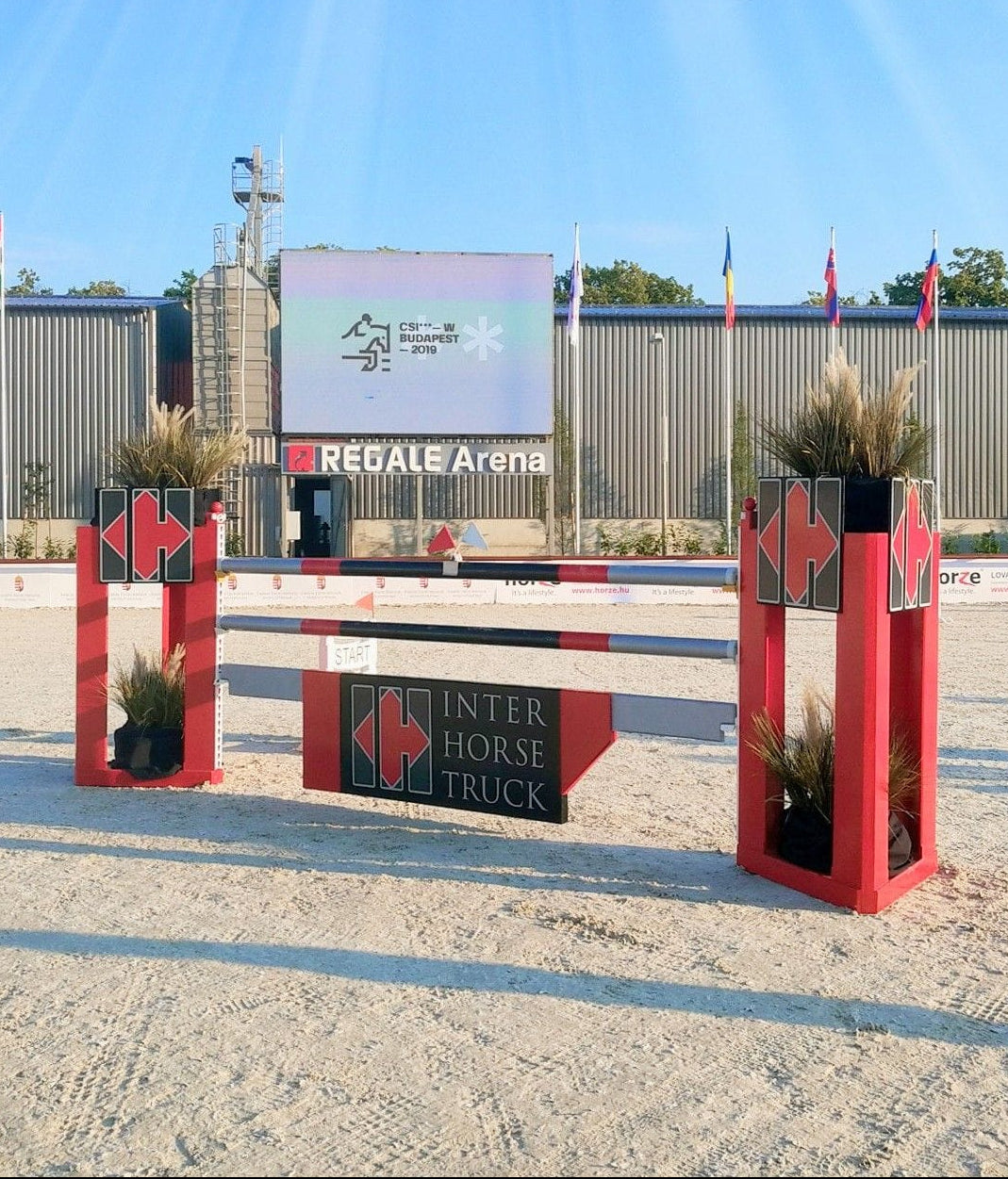 Red equestrian jumps with 'Inter Horse Truck' branding in an outdoor setting.
